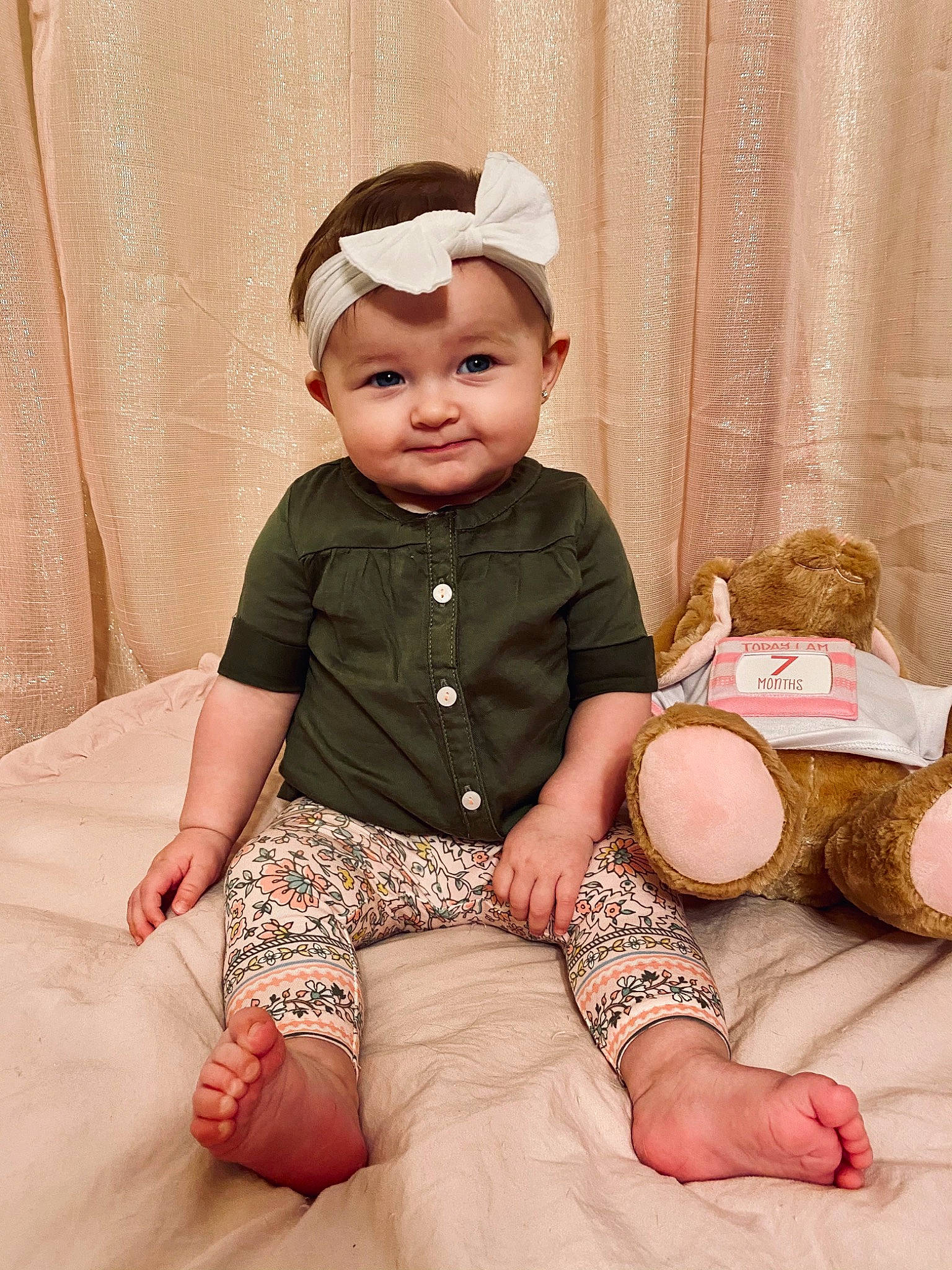 Khloe is registered to the contest to win money with this photo: baby, baby_toddler_clothing, child, comfort, embellishment, flash_photography, happy, headgear, headwear, human, human_leg, joy, person, pink, sitting, skin, sleeve, smile, stuffed_toy, thigh