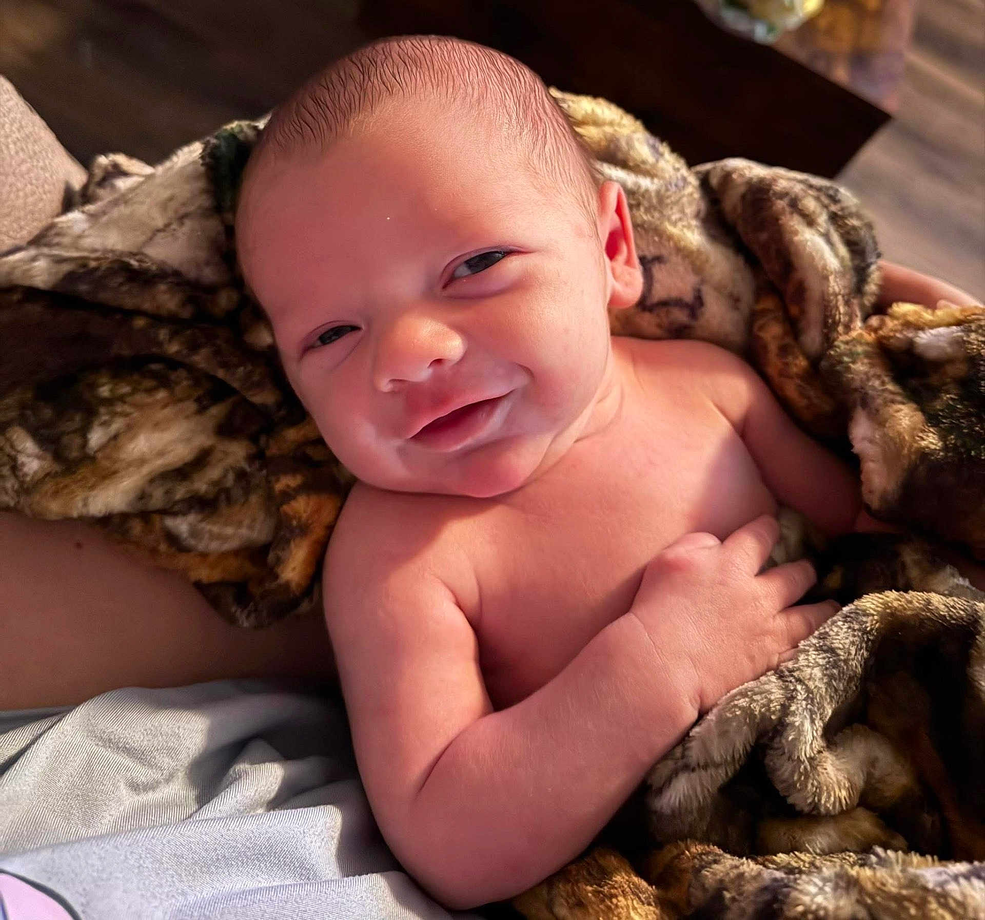 Tamen joined the competition — help win amazing prizes! baby, newborn, blanket, smile, eyes, hand, skin, face, head, couch, cozy, plush, portrait, indoors, bed, resting, closeup, soft_lighting, infant, human