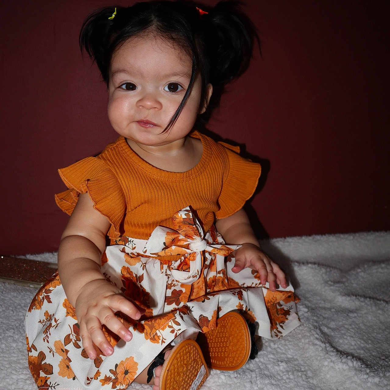 Stormi joined the competition — help win amazing prizes! baby, bodypart, clothing, couch, dress, face, finger, footwear, furniture, hand, happy, head, knitwear, person, photography, portrait, shoe, sitting, smile, sweater