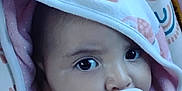 Ava joined the competition — help win amazing prizes! baby, child, pacifier, hand, hooded_towel, face, eyes, infant, cute, close-up, pattern, fabric, soft, comfort, person, skin, expression, indoor, young, cozy