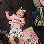 Ava joined the competition — help win amazing prizes! baby, infant, smiling, lying_down, clothing, headband, pillow, cartoon_character, minnie_mouse, bed, blanket, cute, happy, child, indoors, toy, pastel_colors, patterned_clothing, pacifier, comfort