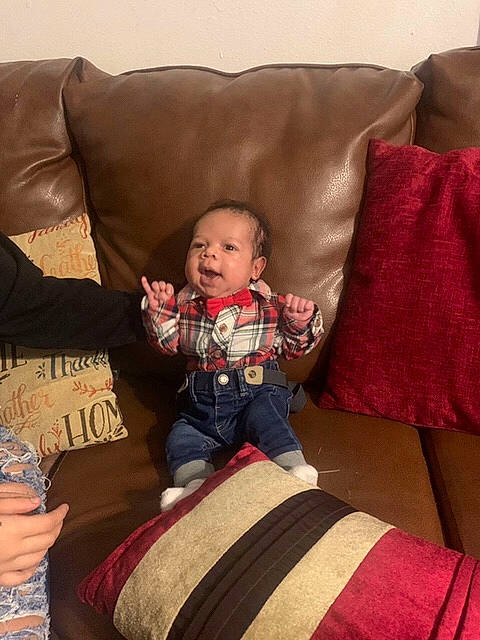 Wayne joined the competition — help win amazing prizes! baby, baby_toddler_clothing, comfort, couch, cushion, hand, home_accessories, human, human_body, lap, linens, living_room, person, pillow, sitting, slipcover, sock, studio_couch, textile, throw_pillow