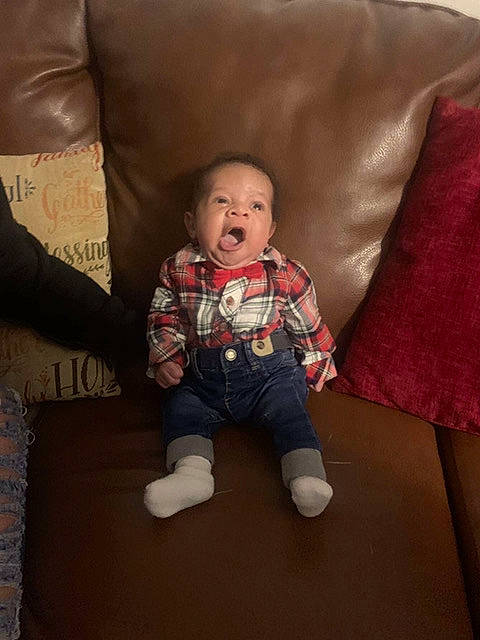 Wayne is registered to the contest to win money with this photo: baby, baby_toddler_clothing, comfort, couch, cushion, home_accessories, human_body, lap, linens, living_room, person, pillow, plaid, slipcover, sock, tartan, textile, throw_pillow, toddler