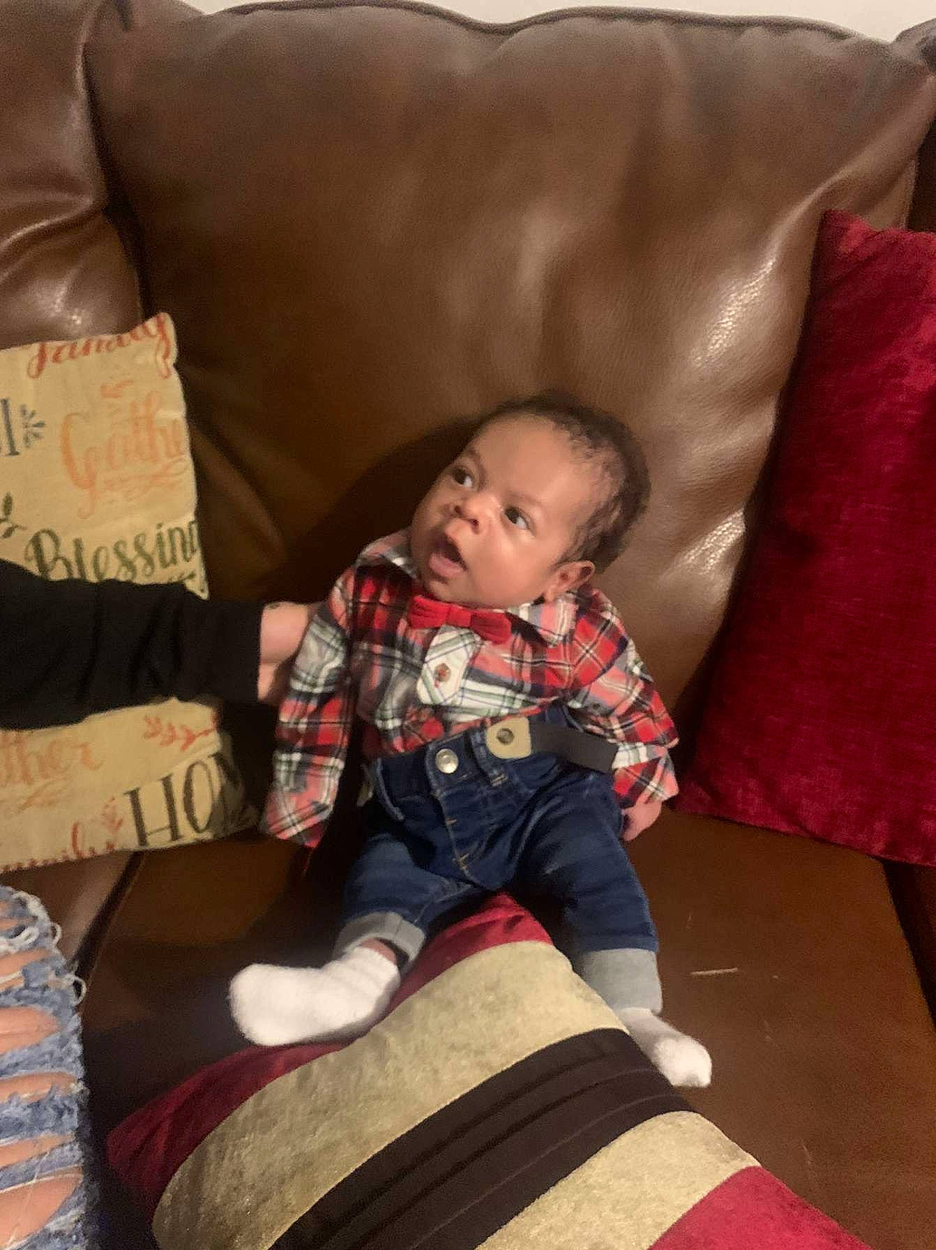 Wayne is registered to the contest to win money with this photo: baby, baby_toddler_clothing, child, comfort, couch, cushion, home_accessories, lap, linens, living_room, person, pillow, slipcover, sock, throw_pillow, toddler