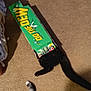 cat, black_cat, tail, box, cardboard_box, mountain_dew, carpet, indoor, pet, playful, hiding, animal, feline, paw, two_cats, shadow, floor, funny, curious, domestic_animal