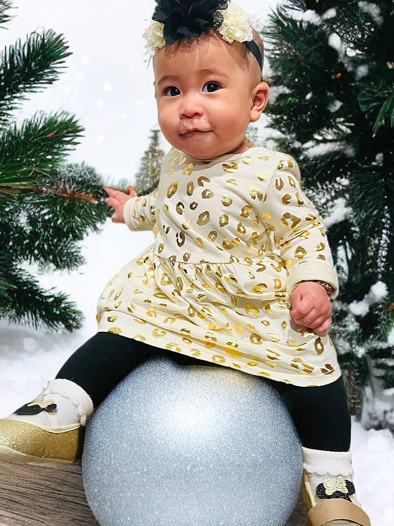 Sylvie joined the competition — help win amazing prizes! accessories, baby, clothing, conifer, dress, face, fir, footwear, happy, head, pants, person, photography, plant, portrait, pottedplant, shoe, smile, sphere, tree