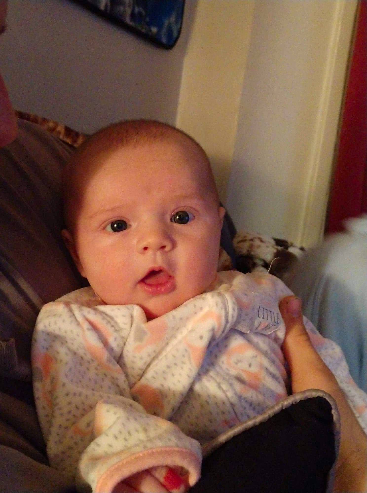 Adilyn joined the competition — help win amazing prizes! baby, cheek, child, chin, ear, electronic_device, eye, face, finger, head, iris, lip, mouth, nose, person, sitting, skin, thumb, toddler