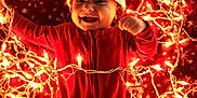 Isaiah Jr. is registered to the contest to win money with this photo: baby, blanket, celebration, cheerful, child, christmas, cozy, cute, festive, glowing_lights, holiday, indoors, infant, lights, lying_down, portrait, red_onesie, santa_hat, smiling, snowflake_pattern