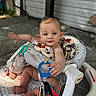 Bria is registered to the contest to win money with this photo: baby, infant, walker, blanket, toy, blue_eyes, sitting, outdoor, furniture, patterned, skin, foot, hand, face, expression, child, comfort, playtime, home, cute