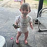 Bria joined the competition — help win amazing prizes! toddler, child, onesie, outdoor, patio, toy, barefoot, curious, playground, sand, person, cute, smiling, daylight, grass, fence, chair, concrete, clothing, baby