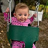 Bria joined the competition — help win amazing prizes! child, toddler, swing, playground, outdoor, pink_clothing, patterned_onesie, happy, blue_eyes, holding_chains, metal_chains, green_swing_seat, autumn_leaves, blurred_background, daylight, portrait, smiling, cute, young_child, fun