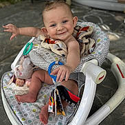 Bria joined the competition — help win amazing prizes! baby, smiling, walker, toy, blanket, child, happy, face, feet, hand, outdoor, patterned, plastic, seat, playful, infant, cute, person, floor, expression