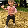 Bria is registered to the contest to win money with this photo: toddler, child, outdoor, sand, play, happy, running, messy, pink_shirt, black_pants, toy_car, grass, tree, nature, daylight, smiling, person, footwear, casual_clothing, dirt