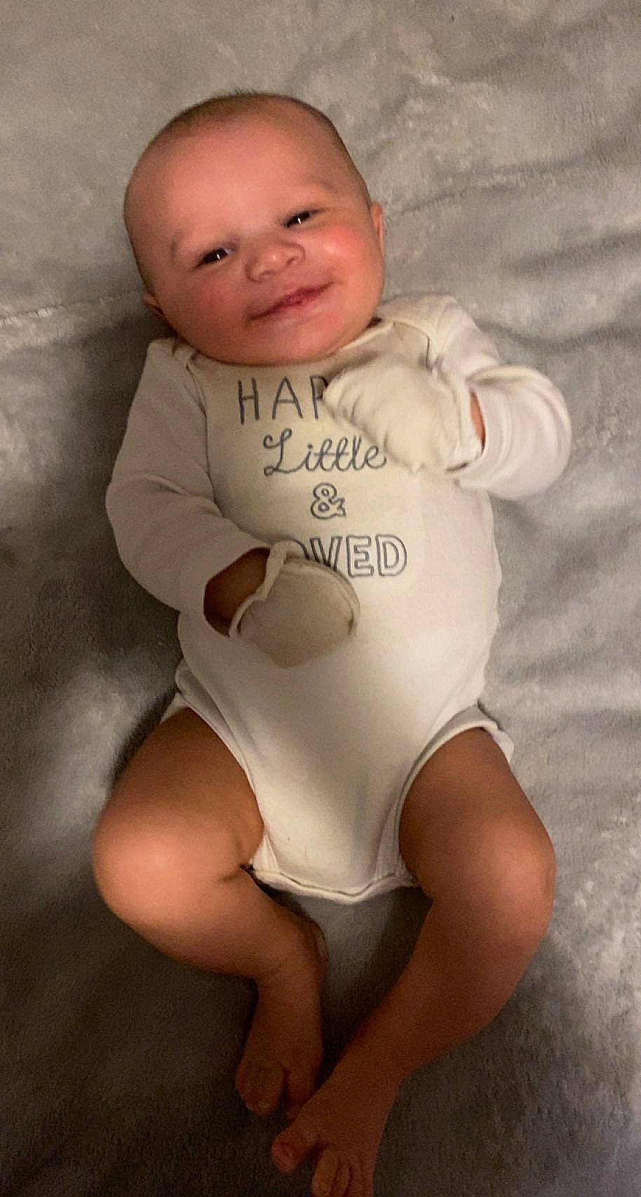 Jaxton is registered to the contest to win money with this photo: baby, baby_toddler_clothing, cheek, comfort, eye, face, hand, happy, head, human_body, infant_bodysuit, joy, knee, leg, neck, person, shoulder, skin, sleeve, smile