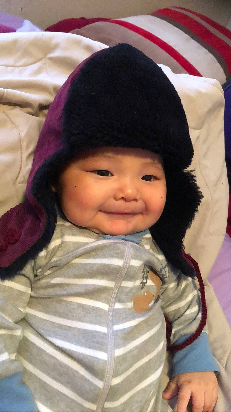 Phillip is registered to the contest to win money with this photo: baby, black_hair, bonnet, cap, cheek, child, hat, headgear, joy, person, skin, smile, toddler