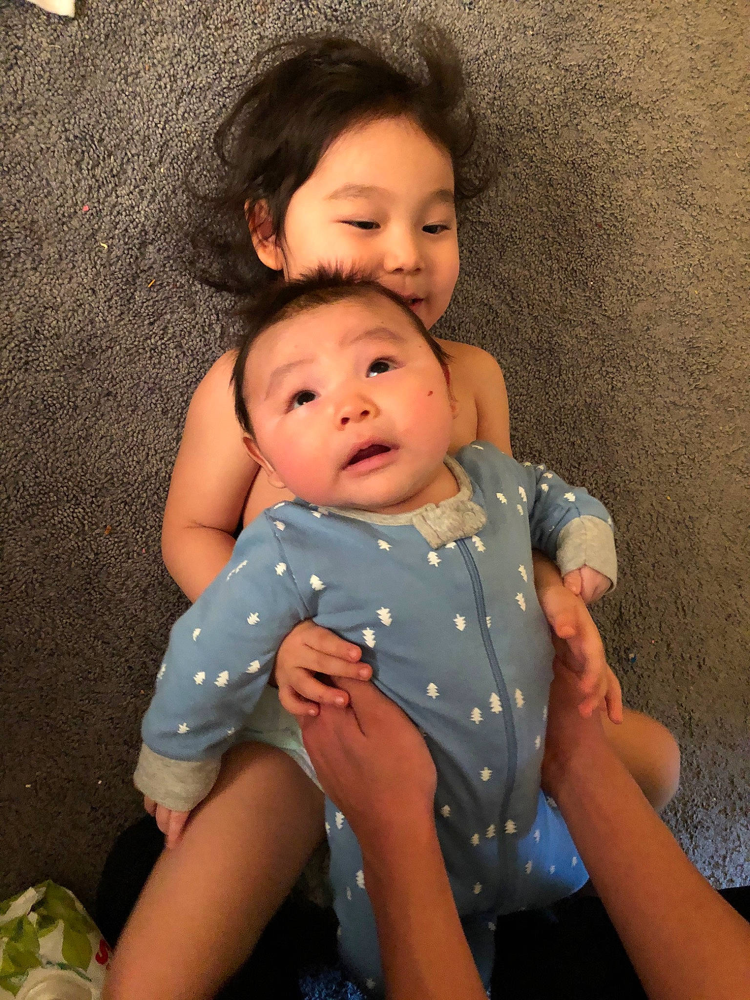 Phillip is registered to the contest to win money with this photo: abdomen, baby, cheek, child, eye, fun, iris, person, sibling, sitting, skin, toddler, trunk