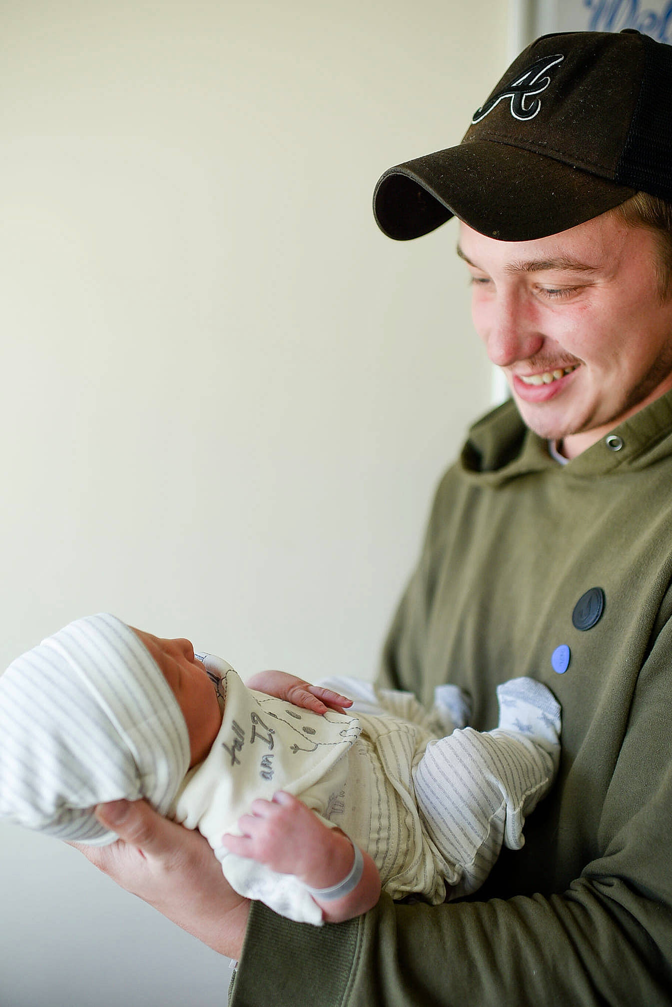 Klayton joined the competition — help win amazing prizes! baby, baseball_cap, cap, child, comfort, cricket_cap, elbow, event, gesture, glove, hand, headwear, joy, person, personal_protective_equipment, service, sitting, sleeve, smile, soldier