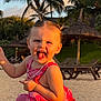beach, casual_clothing, child, happy, holiday, laughing, nature, necklace, outdoor, palm_trees, pink_outfit, playful, portrait, sand, smile, summer, sunlight, sunset, toddler, vacation