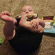 Frederick joined the competition — help win amazing prizes! baby, child, carpet, foot, hand, soft_toy, book, animal_illustration, indoor, black_clothing, playing, cute, infant, person, lying_down, carpet_texture, toddler, childhood, floor, curious