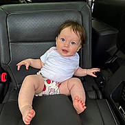 Elliana joined the competition — help win amazing prizes! baby, barefoot, black, blue_eyes, car_interior, car_seat, child, curly_hair, cute, happy, infant, innocent, leather, portrait, seatbelt, shorts, sitting, strawberry_pattern, white_shirt, young_child