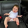 baby, barefoot, black, blue_eyes, car_interior, car_seat, child, curly_hair, cute, happy, infant, innocent, leather, portrait, seatbelt, shorts, sitting, strawberry_pattern, white_shirt, young_child