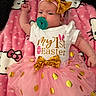 baby, infant, pacifier, headband, bow, pink_tutu, golden_polka_dots, white_onesie, easter, hello_kitty_blanket, lying_down, cute, celebration, child, toddler, soft_blanket, indoors, festive, clothing, portrait