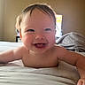 Elliana joined the competition — help win amazing prizes! baby, smiling, happy, infant, child, bed, blanket, indoor, face, skin, hair, expression, person, cute, portrait, young, cheerful, lying, rosy_cheeks, natural_light