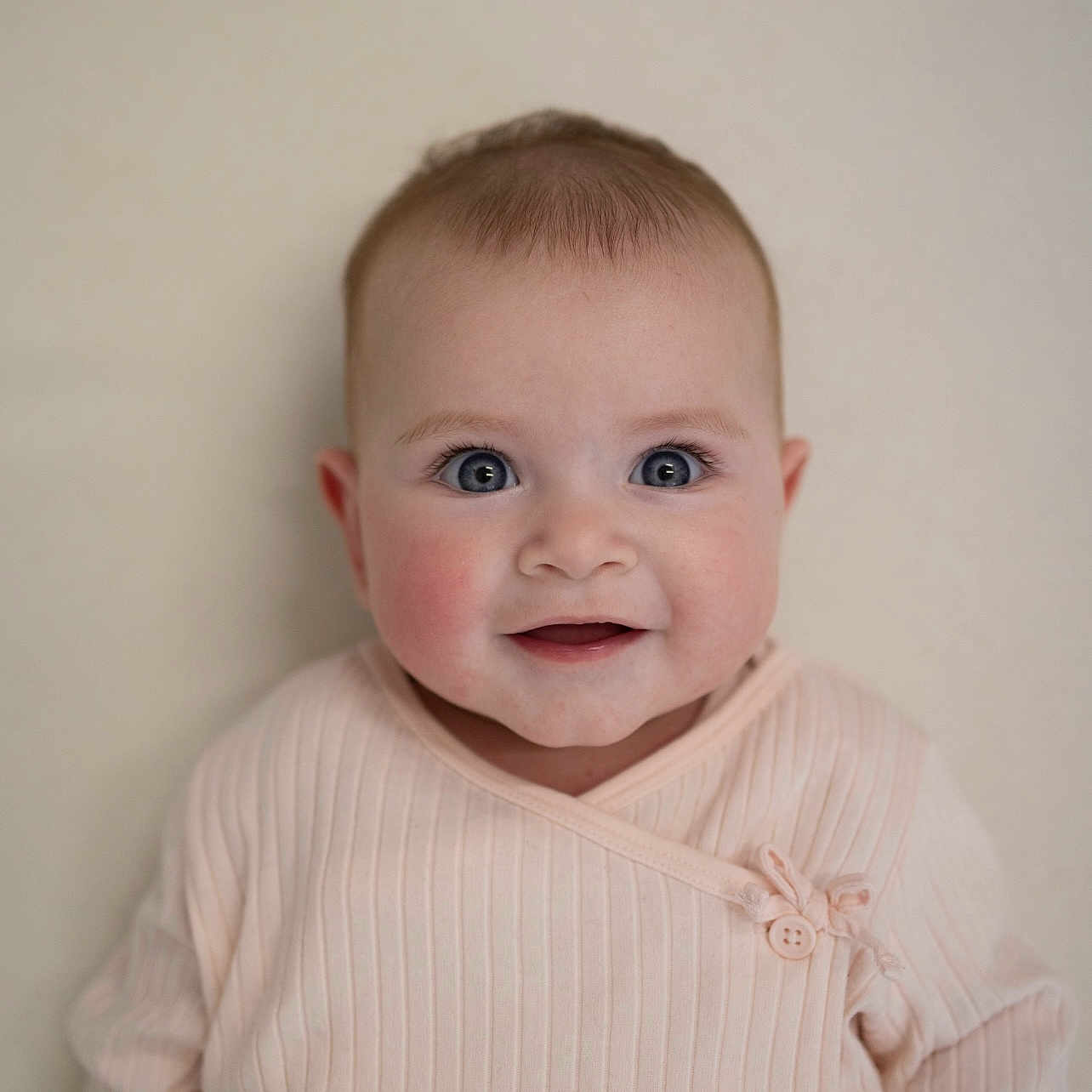 Florence joined the competition — help win amazing prizes! apparel, baby, blue_eyes, buttoned, child, closeup, cute, face, happy, human, indoors, infant, pink_clothing, portrait, ribbed_fabric, sitting, skin, smiling, soft_lighting, young