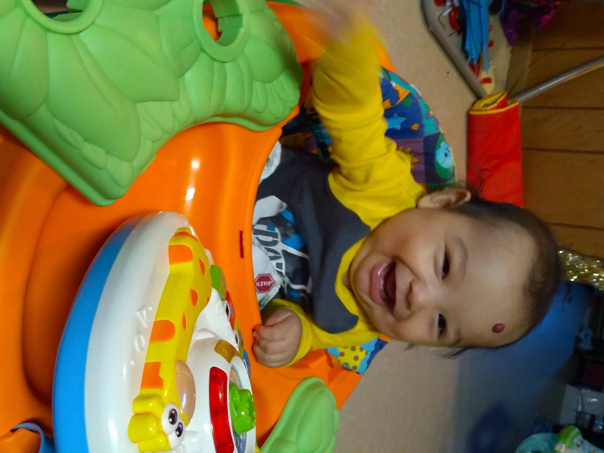 Frank is registered to the contest to win money with this photo: baby, baby_products, baby_toddler_clothing, baby_toys, child, fun, green, happy, hulk, leisure, organ, person, play, recreation, room, smile, snapshot, t_shirt, toddler, toy