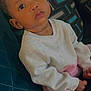 Tyanna joined the competition — help win amazing prizes! baby, child, face, sitting, indoors, couch, cushion, clothing, sweater, pants, striped, earrings, person, portrait, young_child, cute, expression, home, comfort, looking_up