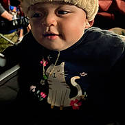 Hope joined the competition — help win amazing prizes! animal_hat, baby, background_people, casual, cat_design, child, clothing, cute, dim_lighting, expression, face, hat, indoors, infant, necklace, person, portrait, seated, shirt, soft_texture
