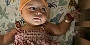 Hope joined the competition — help win amazing prizes! baby, child, girl, headband, flower, dress, crib, mattress, animal_pattern, giraffe, elephant, bracelet, arm, laying_down, curious, indoors, infant, cute, smiling, person