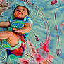 Hope joined the competition — help win amazing prizes! baby, child, blanket, floral_pattern, sand, outdoor, colorful_clothing, infant, cute, portrait, lying_down, summer, playtime, nature, skin, happy, young, small, person, casual