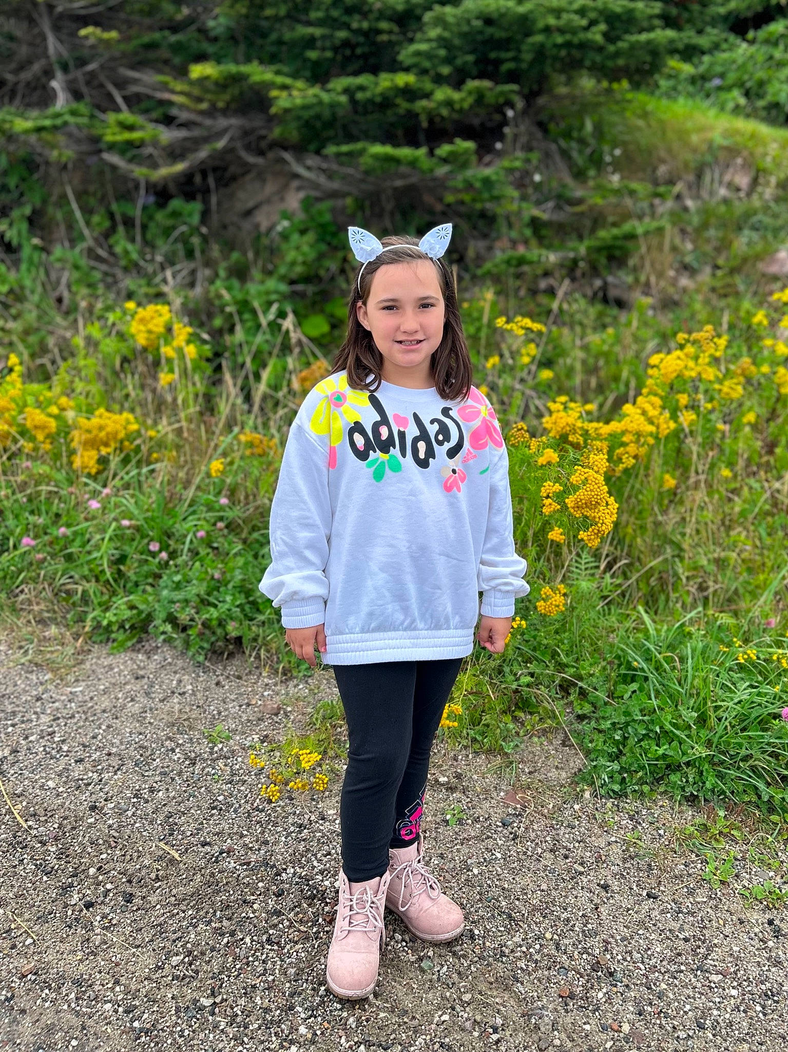 Gabriella is registered to the contest to win money with this photo: cap, eye, flower, fun, grass, grassland, happy, hat, jacket, joy, landscape, leisure, people_in_nature, person, plant, recreation, sleeve, smile, soil, t_shirt