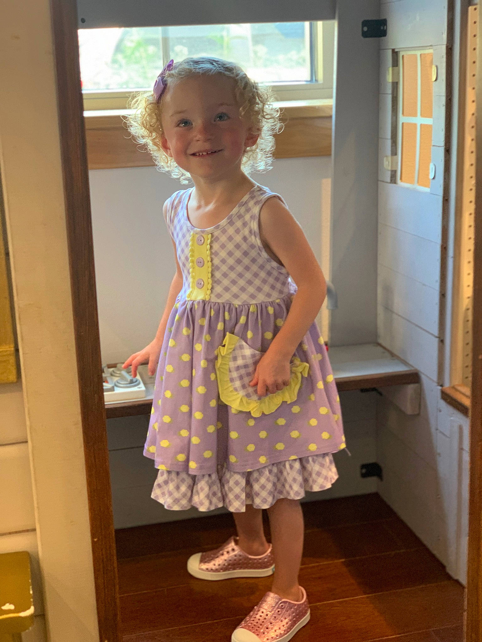 Natalie joined the competition — help win amazing prizes! baby_toddler_clothing, day_dress, door, drawer, dress, fashion_design, flooring, fun, house, human_leg, joy, knee, leg, one_piece_garment, pattern, person, sandal, shoe, smile, toddler