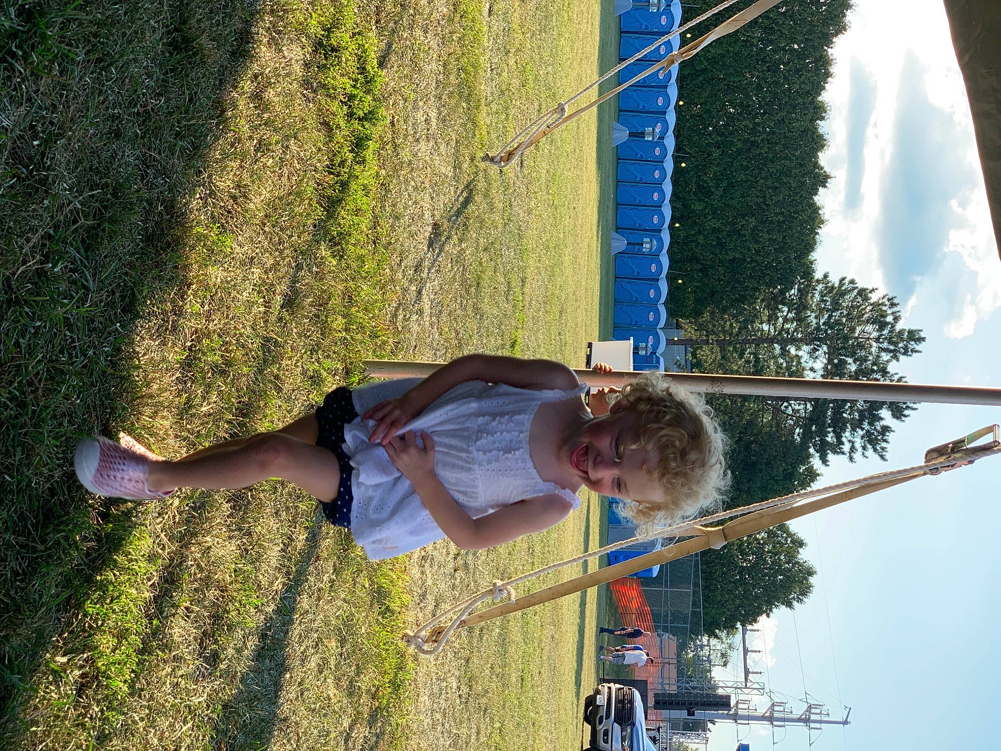 Natalie is registered to the contest to win money with this photo: daytime, elbow, electric_blue, fun, grass, happy, human_leg, joy, leisure, line, people_in_nature, person, plant, recreation, reflection, shadow, shorts, sky, t_shirt, tree