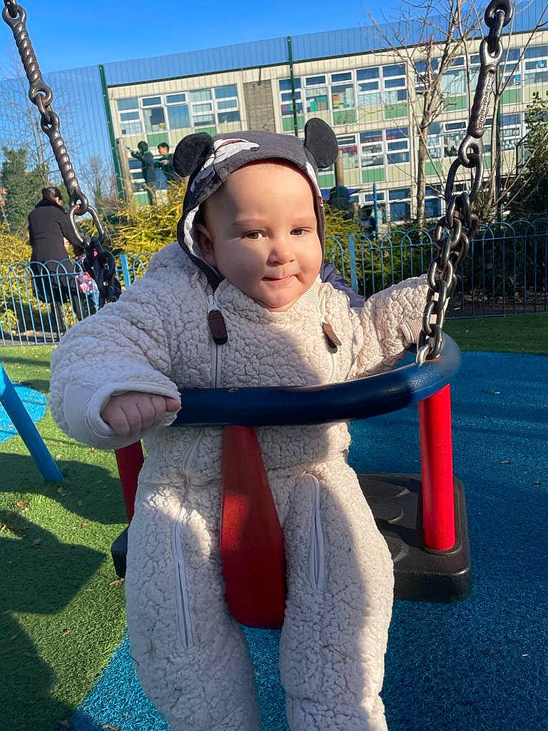 Theodor is registered to the contest to win money with this photo: baby, baby_toddler_clothing, child, city, electric_blue, fun, grass, happy, hat, headwear, joy, leisure, people, person, plant, playground, public_space, recreation, sky, smile