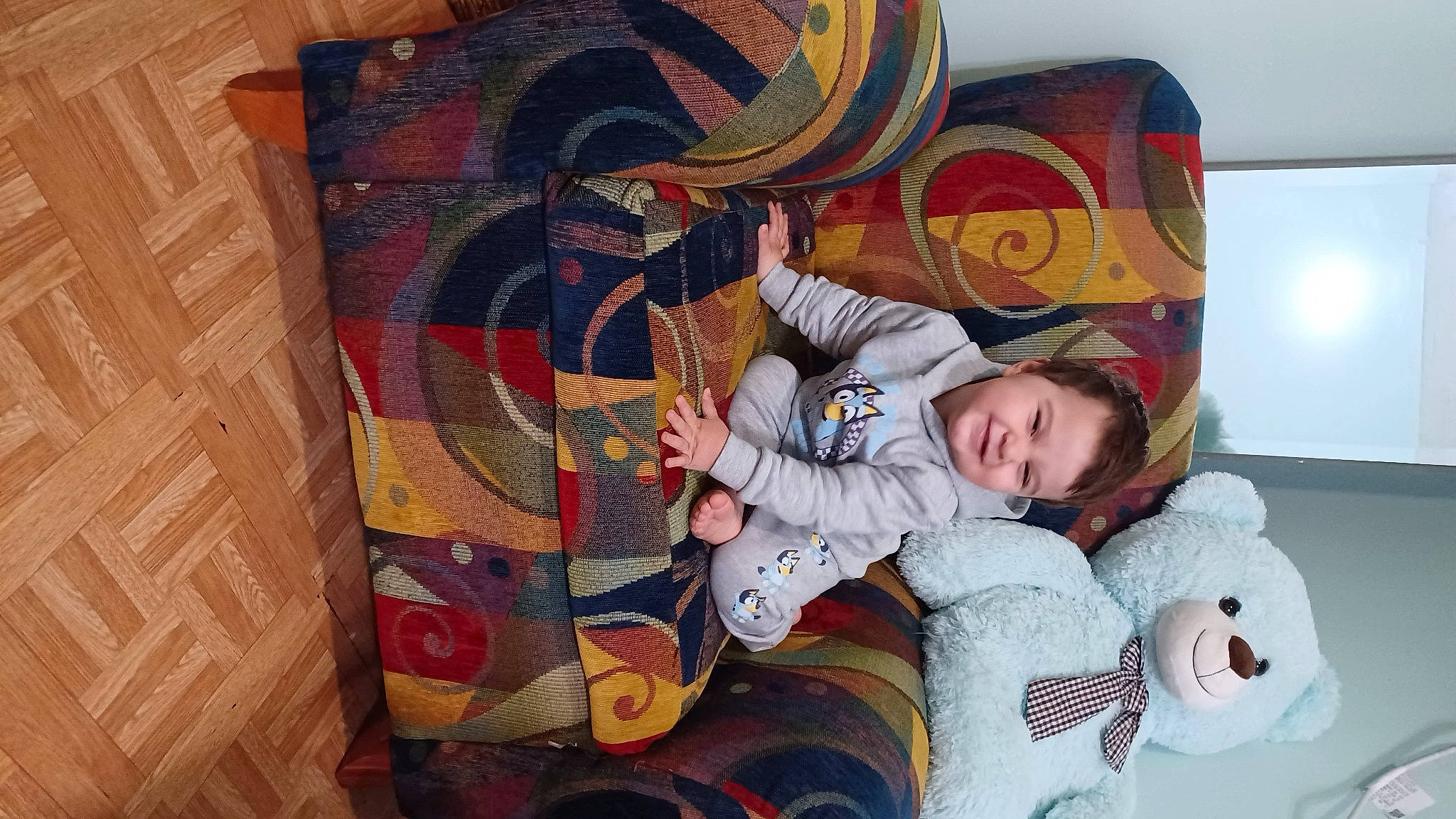 Antonio is registered to the contest to win money with this photo: art, baby, baby_toddler_clothing, child, comfort, fictional_character, flooring, fun, fur, happy, illustration, joy, linens, musical_instrument, pattern, person, room, sitting, toddler, visual_arts