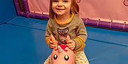 Cléa a rejoint le concours — aidez-le/la à gagner de superbes lots ! balloon, bodypart, child, clothing, face, female, finger, girl, hand, head, indoors, inflatable, outdoors, pants, person, photography, playarea, portrait, purple, toy