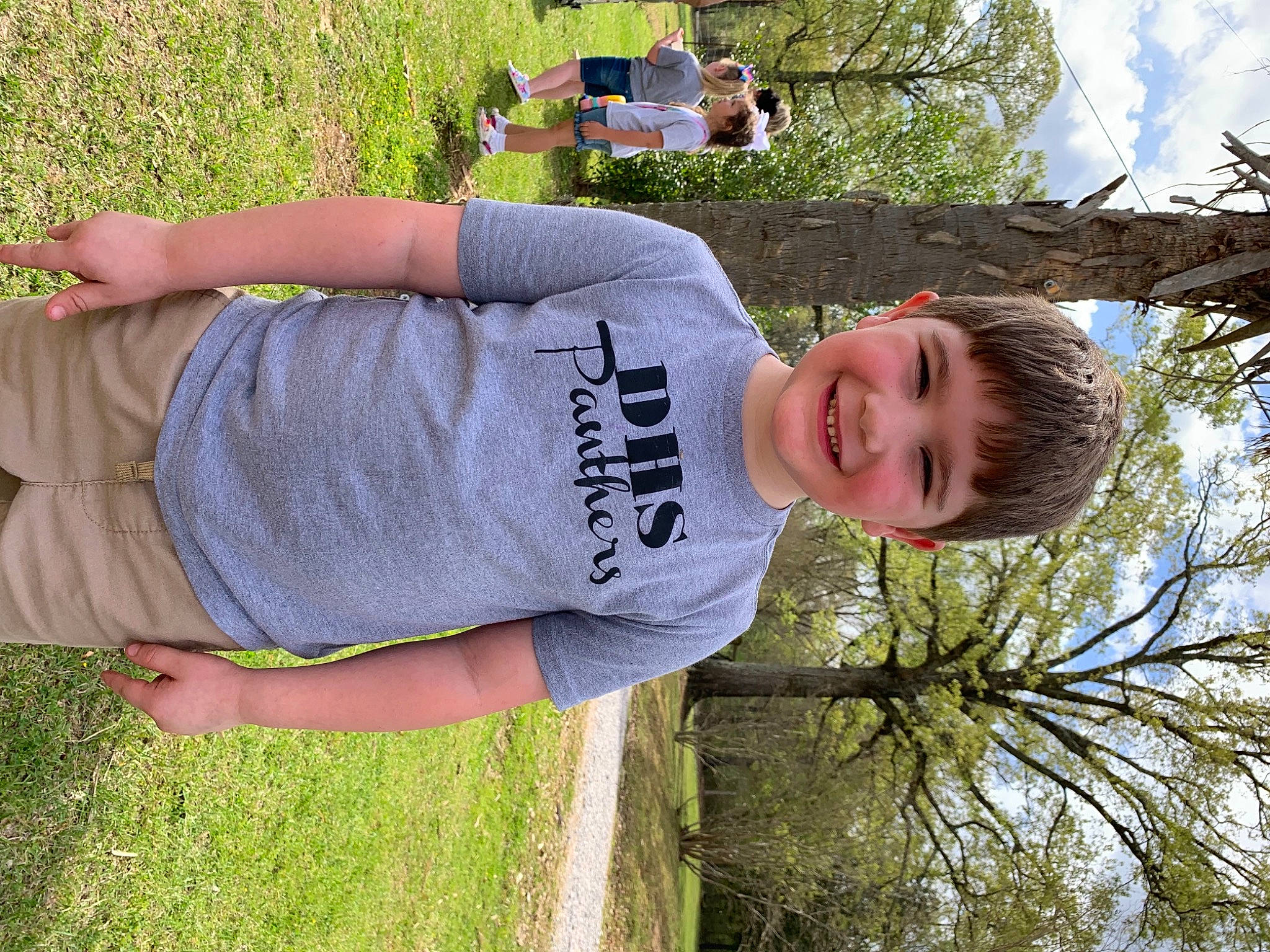 Kimber joined the competition — help win amazing prizes! bench, blurred, child, elbow, facial_expression, fun, grass, happy, joy, leisure, people, people_in_nature, person, plant, sky, sleeve, smile, spring, summer, t_shirt