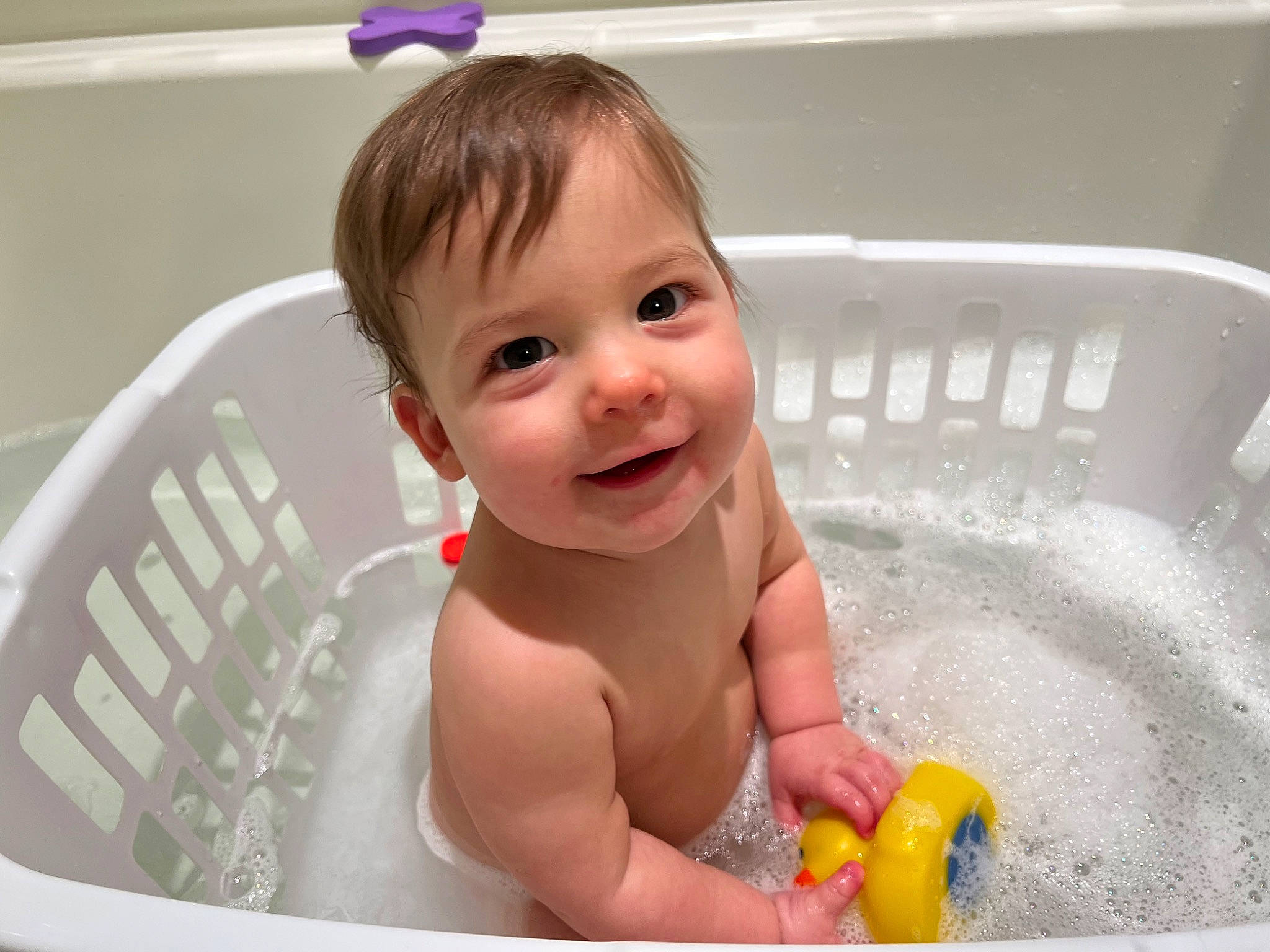 Jayce is registered to the contest to win money with this photo: baby, baby_bathing, baby_products, bath_toy, bathing, bathroom, bathtub, child, fluid, fun, happy, joy, liquid, person, pink, plumbing, plumbing_fixture, product, skin, smile