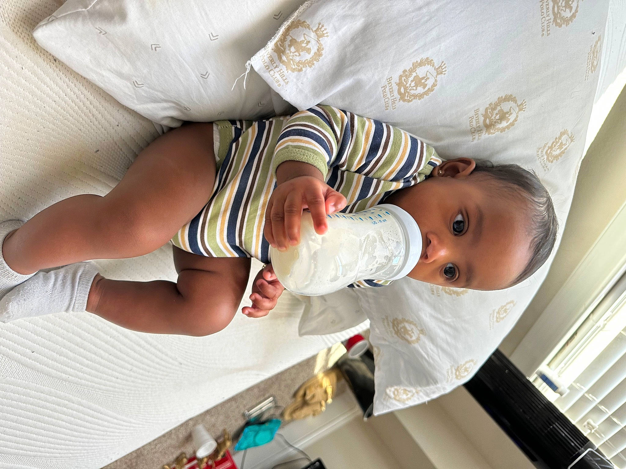 Kason is registered to the contest to win money with this photo: arm, baby, baby_products, baby_toddler_clothing, child, comfort, elbow, finger, gesture, hand, happy, human_leg, nail, person, product, room, sleeve, thumb, toddler, white