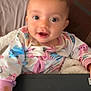 Imoni is registered to the contest to win money with this photo: baby, child, pajamas, cat_prints, laptop, keyboard, blanket, pillow, bed, indoors, smiling, happy, cute, face, person, young_child, cozy, soft_lighting, sitting, hand