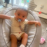 Imoni joined the competition — help win amazing prizes! baby, pacifier, baby_seat, indoor, child, infant, cute, relaxed, soft_focus, carpet, toy, striped, socks, window, daylight, comfort, smiling, face, person, home