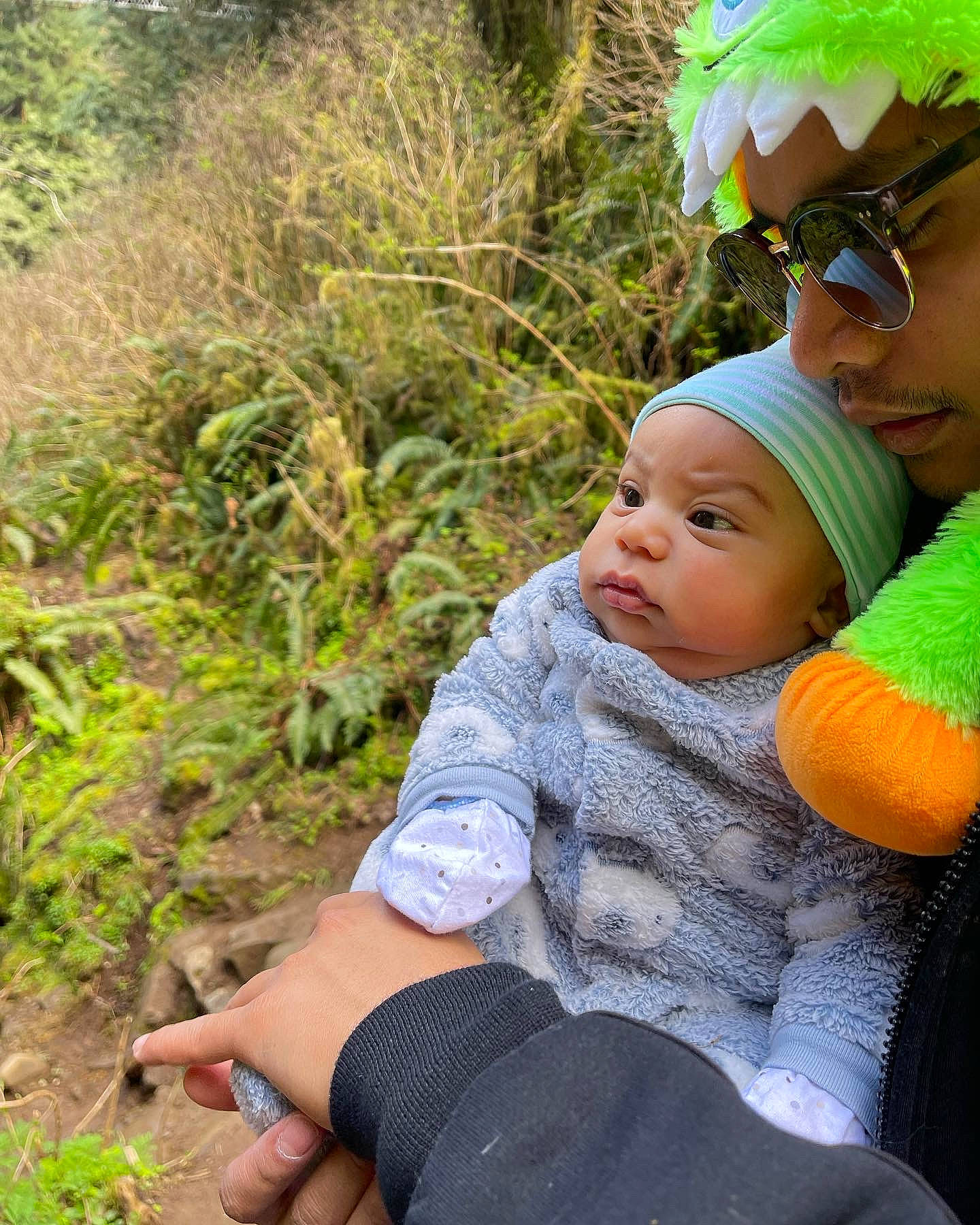 Ryker is registered to the contest to win money with this photo: baby, baby_toddler_clothing, cap, child, fashion_accessory, goggles, grass, green, happy, hat, headwear, leaf, people_in_nature, person, personal_protective_equipment, plant, recreation, sitting, skin, sunglasses