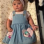 Carina is registered to the contest to win money with this photo: baby, child, headband, denim_dress, minnie_mouse, daisy_duck, plush_toy, floral_blanket, infant, cute, lying_down, indoors, clothing, person, portrait, baby_girl, footwearless, curious, soft_toy, pink