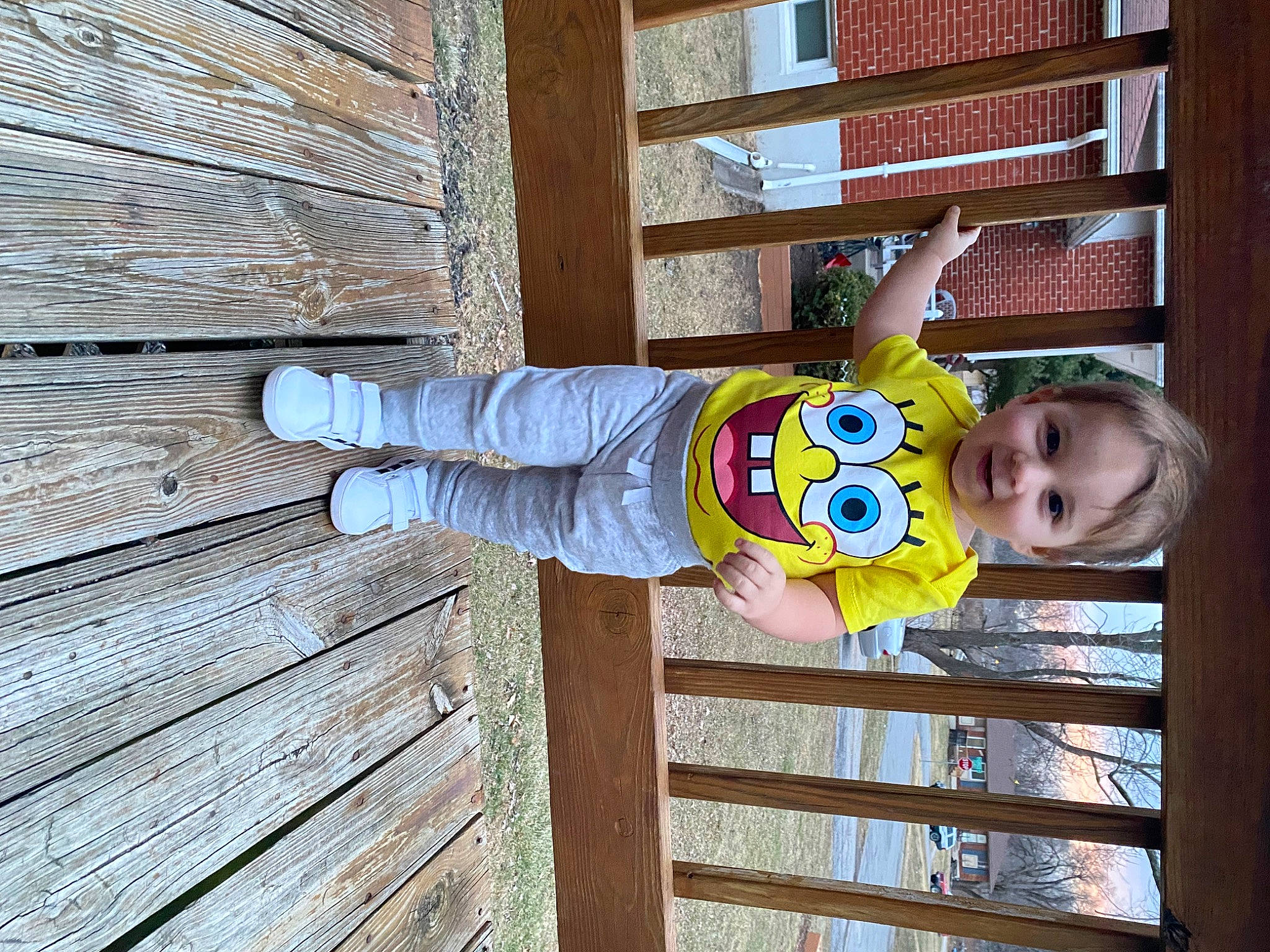 Braxton is registered to the contest to win money with this photo: baby, baby_laughing, baby_safety, baby_toddler_clothing, child, face, fence, fun, happy, hardwood, hat, joy, pattern, person, plank, sleeve, smile, t_shirt, toddler, wood