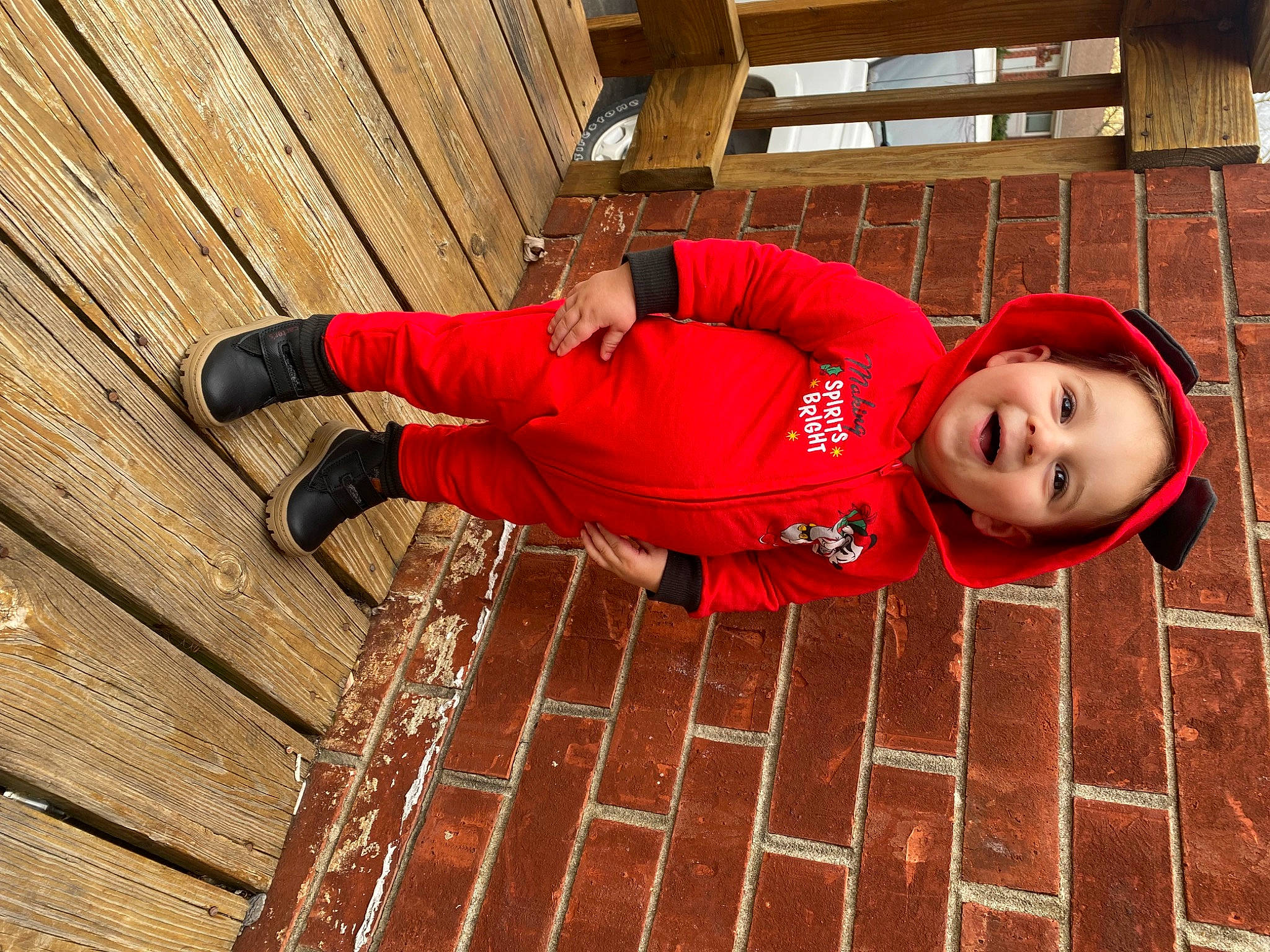 Braxton joined the competition — help win amazing prizes! brick, brickwork, carmine, face, flash_photography, flooring, fun, happy, hardwood, human_leg, leisure, orange, pattern, person, red, sitting, smile, t_shirt, thigh, wood