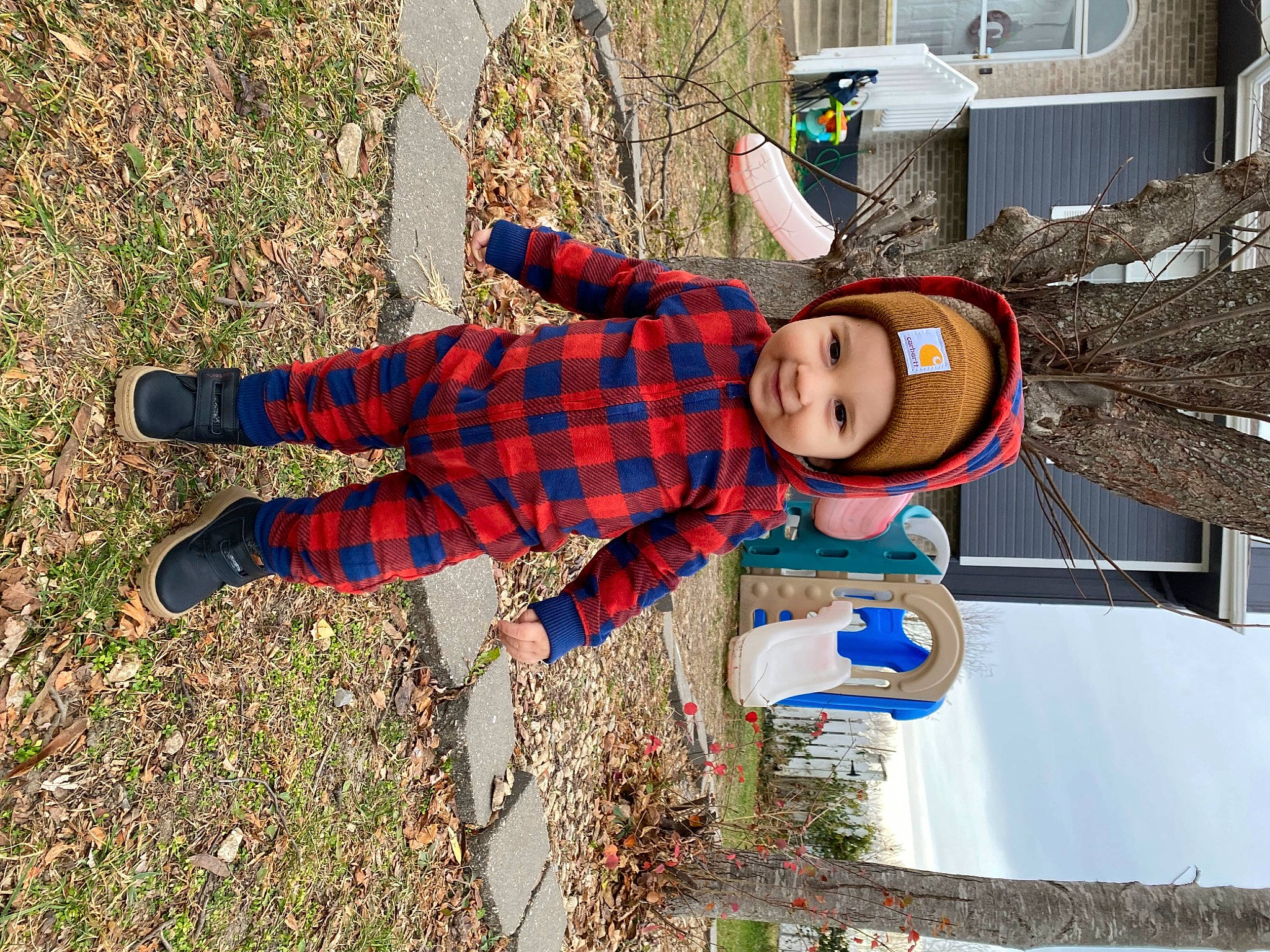 Braxton is registered to the contest to win money with this photo: carmine, child, design, electric_blue, fun, grass, hat, headwear, joy, leisure, pattern, people_in_nature, person, personal_protective_equipment, plaid, plant, recreation, smile, soil, tartan