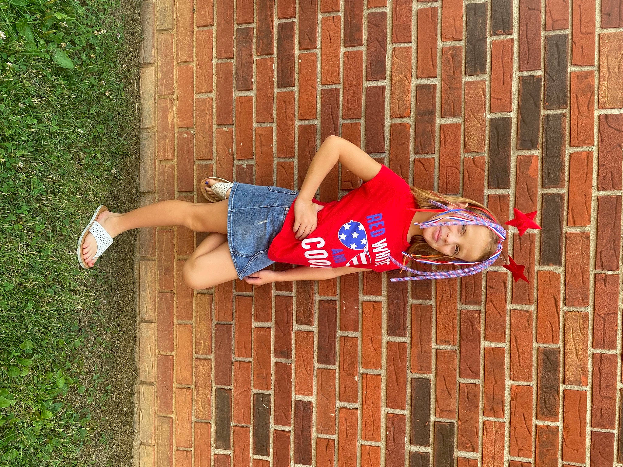Kyleigh is registered to the contest to win money with this photo: arm, brick, brickwork, clothing, dress, footwear, glasses, jeans, knee, leg, orange, people_in_nature, person, plant, red, shoe, shorts, street_fashion, thigh, waist